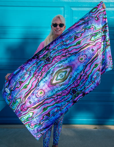 Woman holding SlipIns Beach Towels - Amazing Abalone